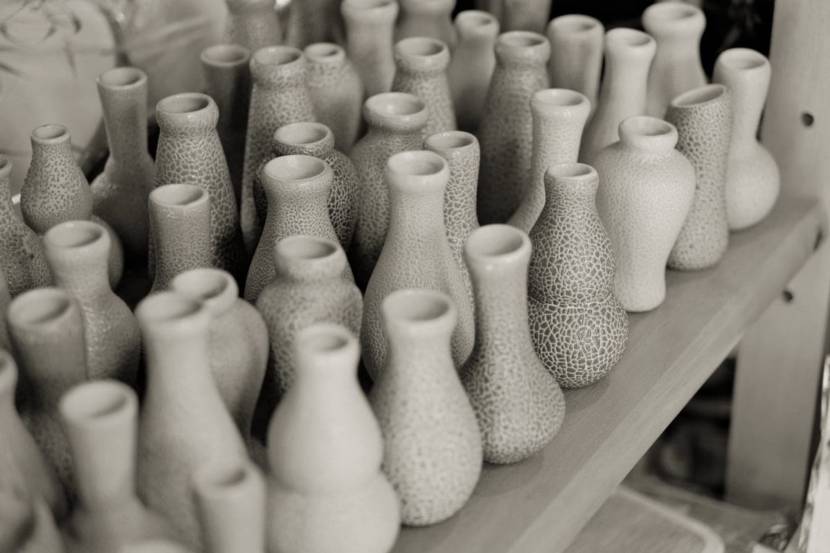 Handmade ceramic vases arranged on a shelf