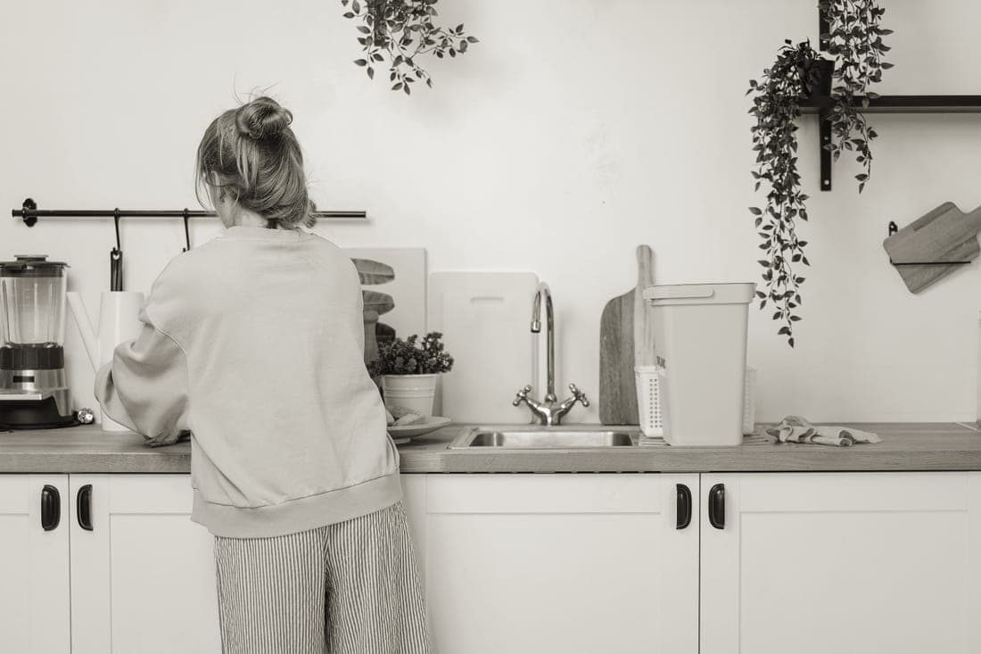A wooden board being cleaned at a kitchen counter
