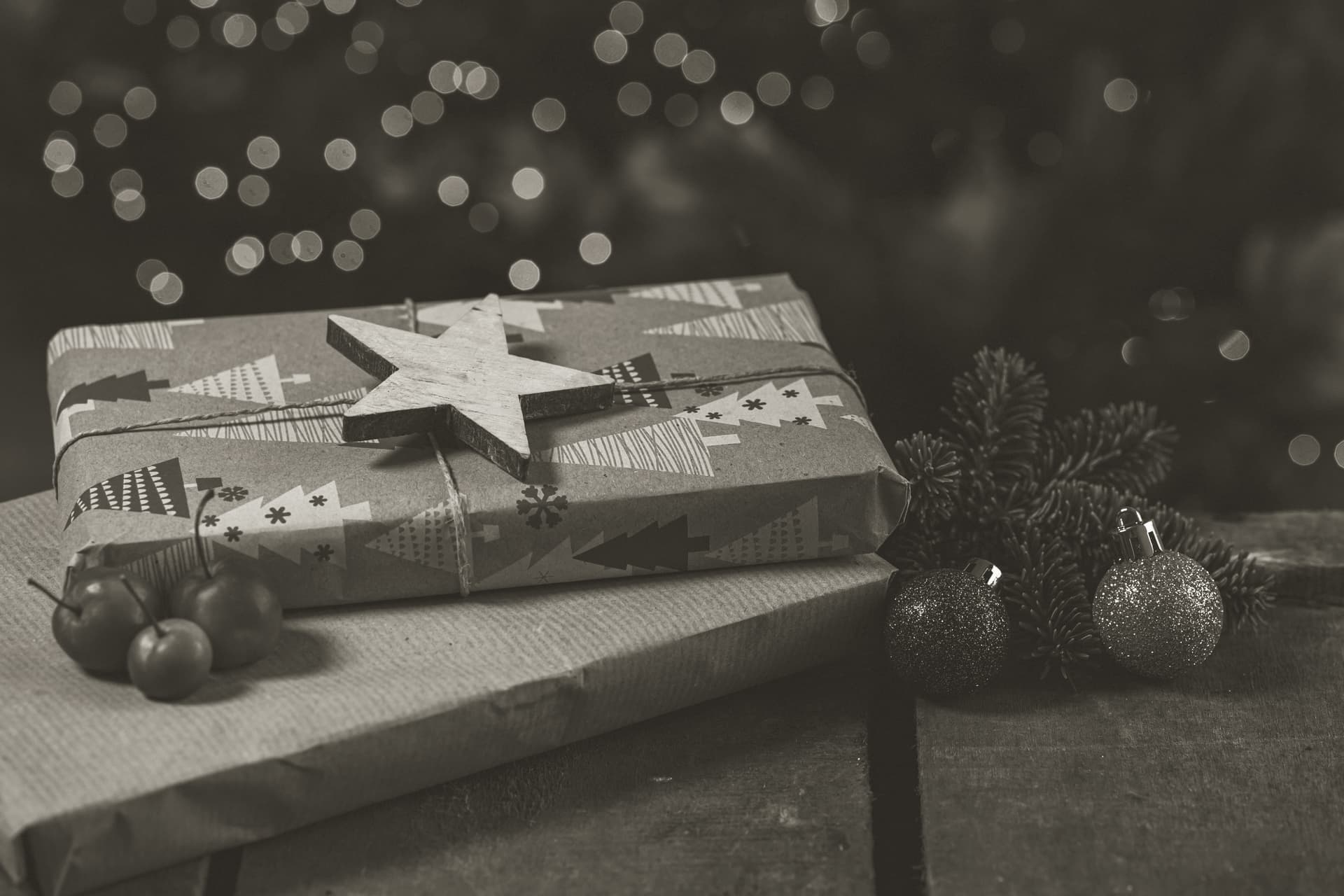 A wrapped gift box on a wooden table in warm light