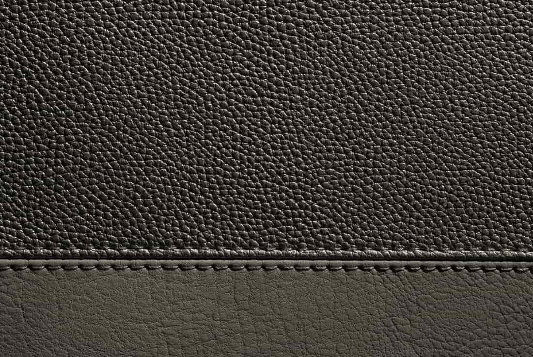 Close-up of brown leather showing grain and stitching