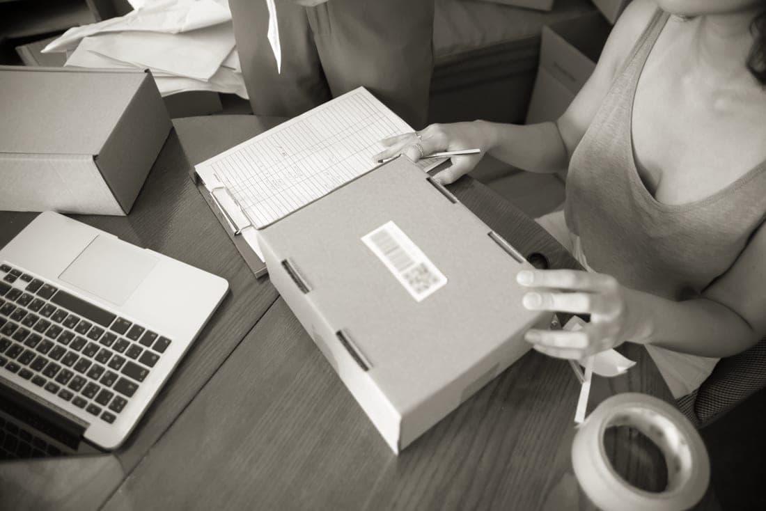 A small business owner packing orders at a table