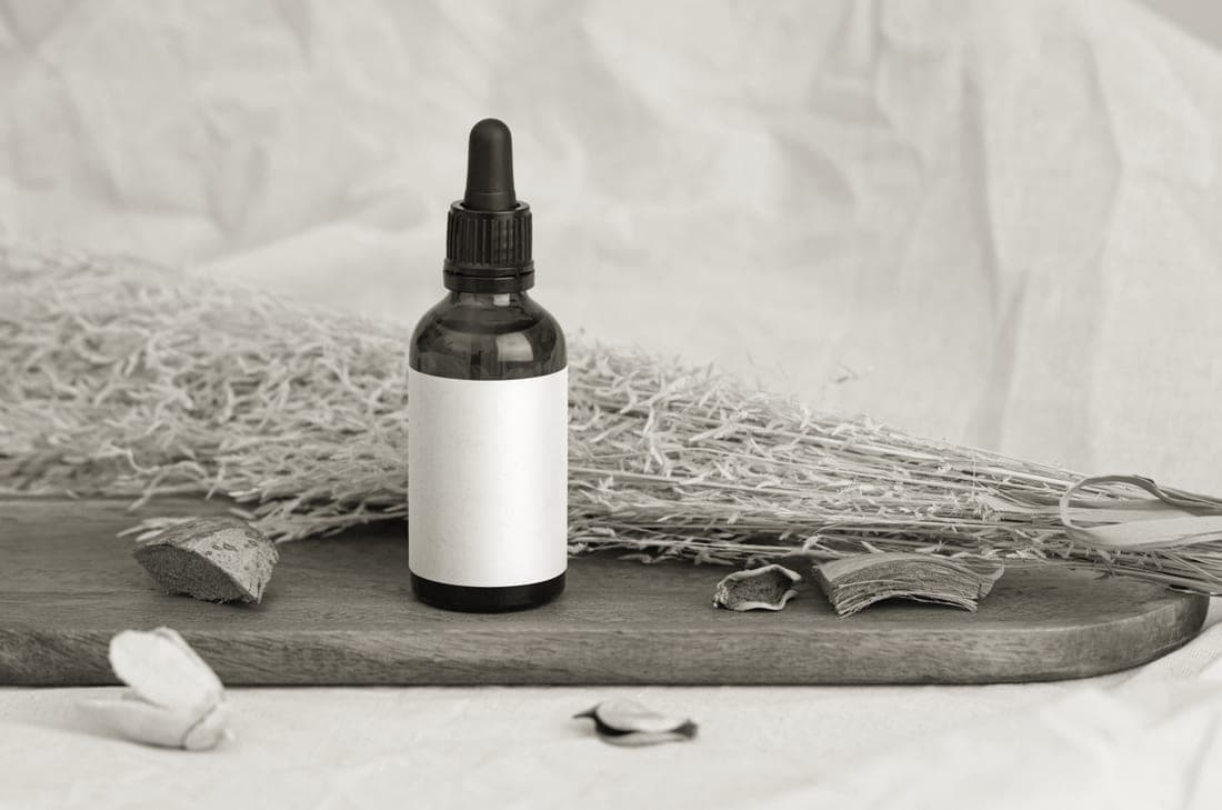 A bottle of oil beside a wooden board