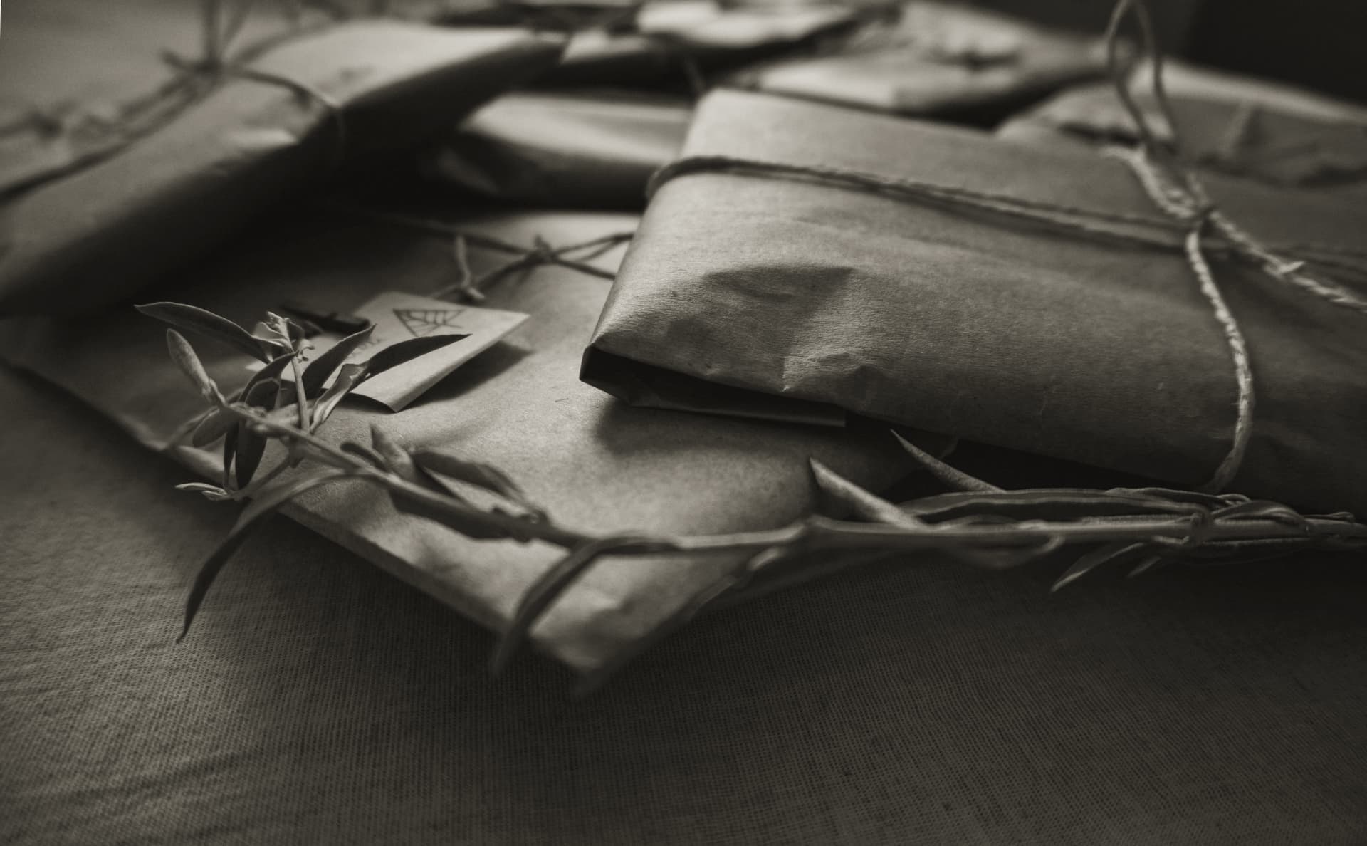 Plain brown paper and natural twine packaging on a work surface